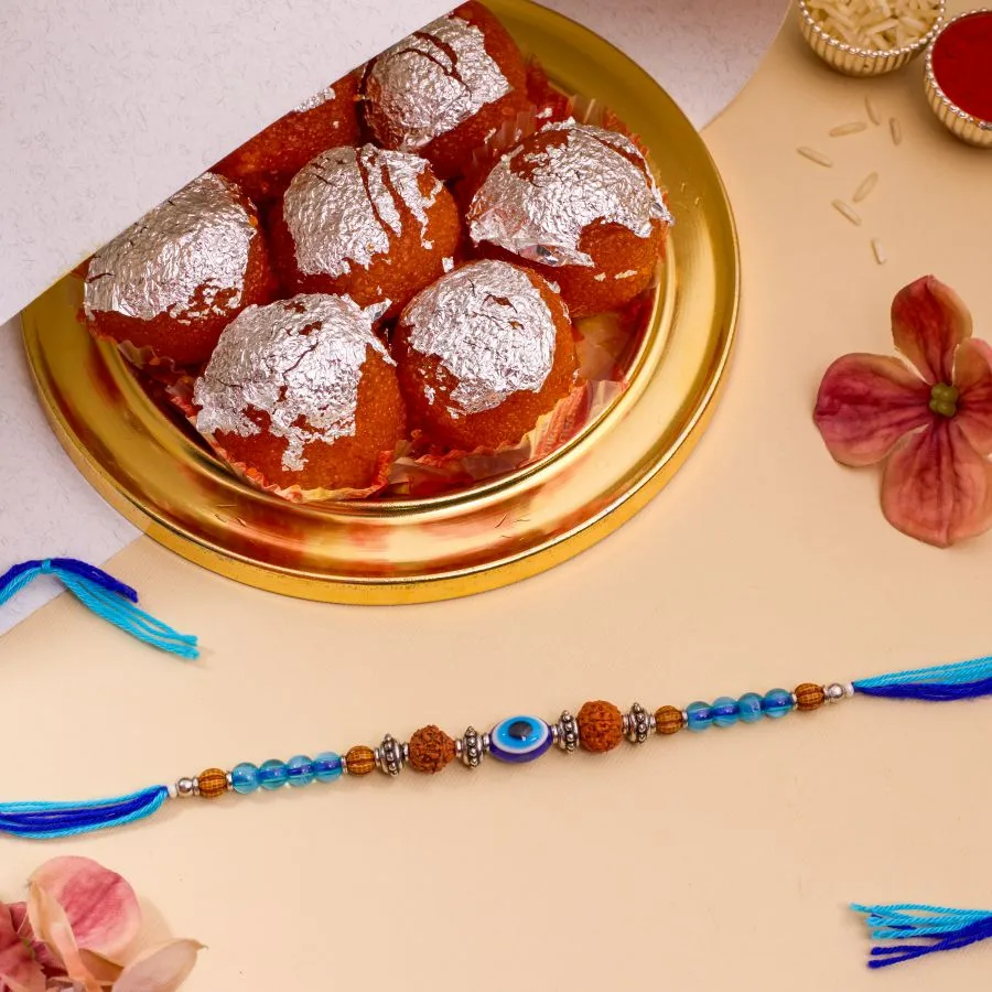 Unique Evil Eye Rakhi N Ghee Laddu Delight
