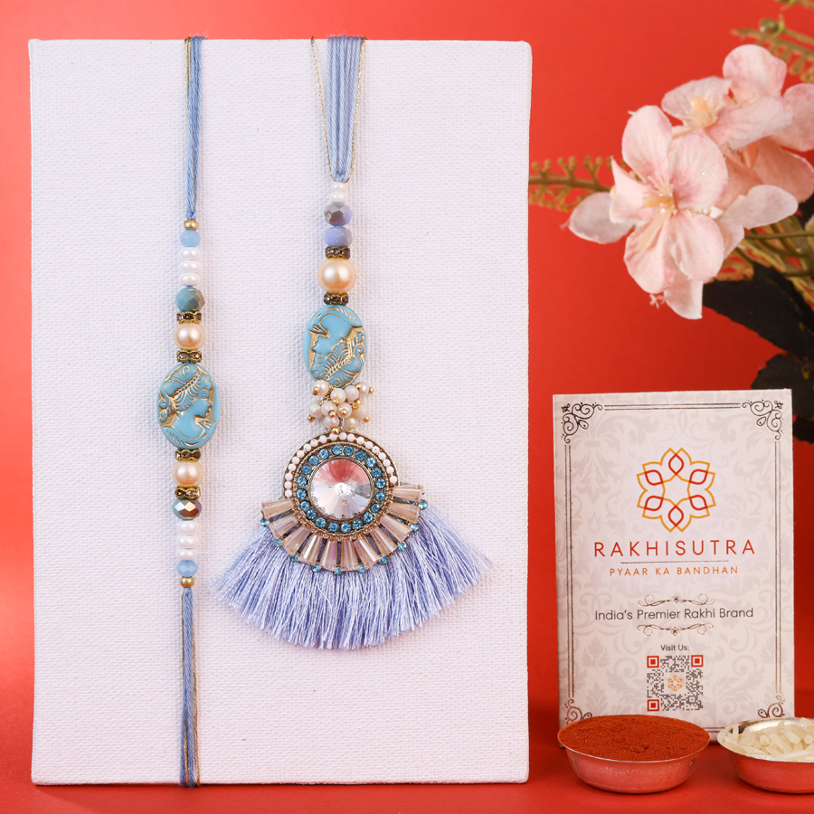 Exclusive Bhaiya Bhabi Rakhi Set featuring rakhis, Roli, Tika, Chawal, and a Message Card.