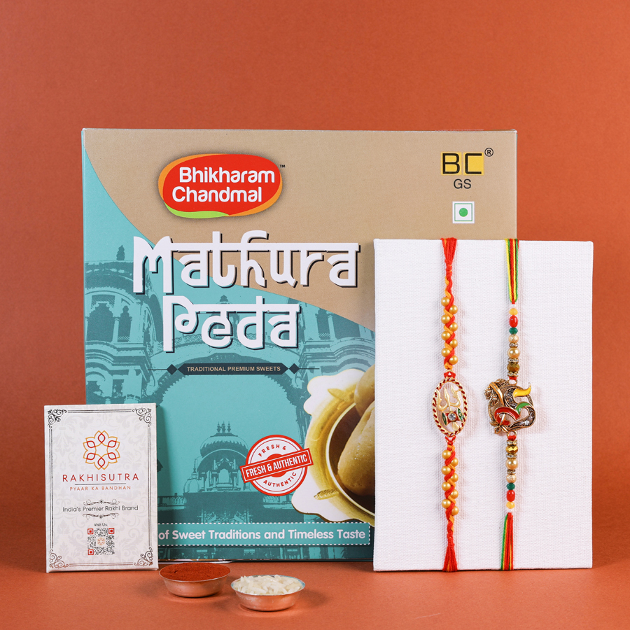 Traditional Rakhi gift set with sweets and accessories.