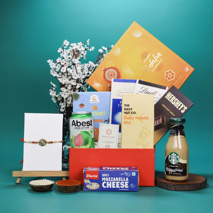 Premium Ganesh Rakhi with gourmet snacks in a gift box